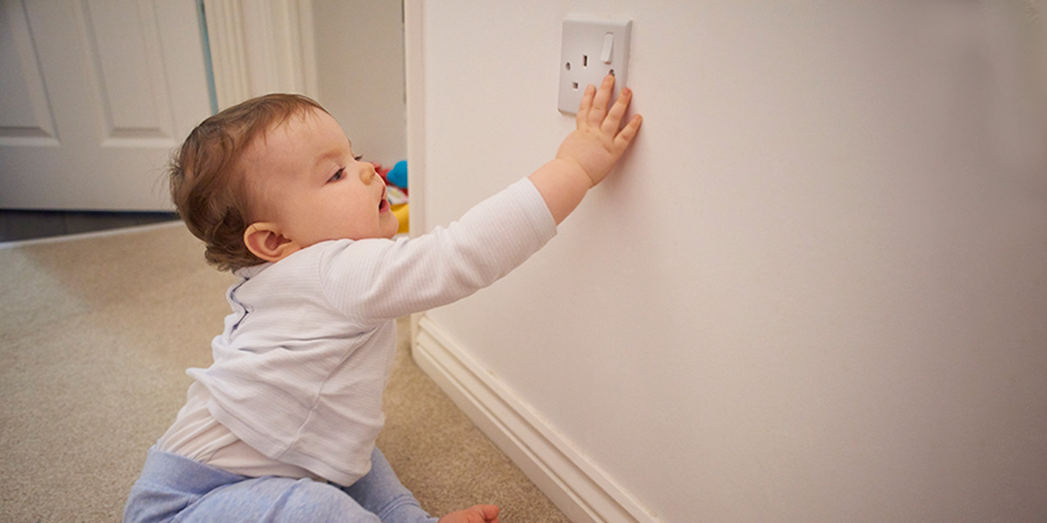 Baby touching a plug